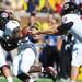 UMass running back and former Michigan player Mike Cox receives the ball from quarterback Mike Wegzyn in the first quarter against UMass at Michigan Stadium on Saturday. Melanie Maxwell I AnnArbor.com